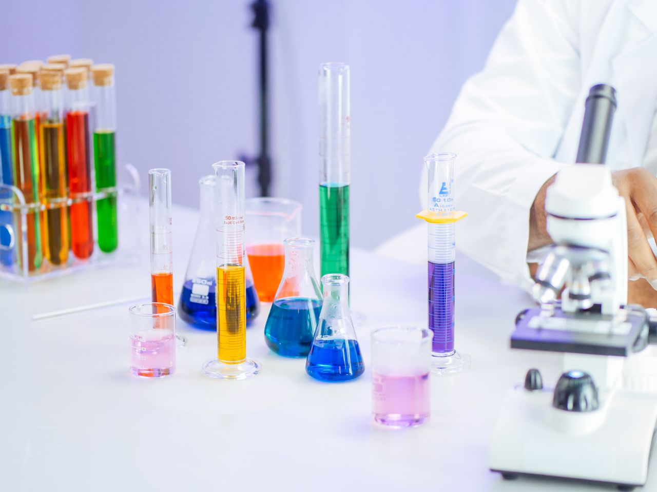 Vibrant laboratory setup with beakers, flasks, and microscope for scientific research.